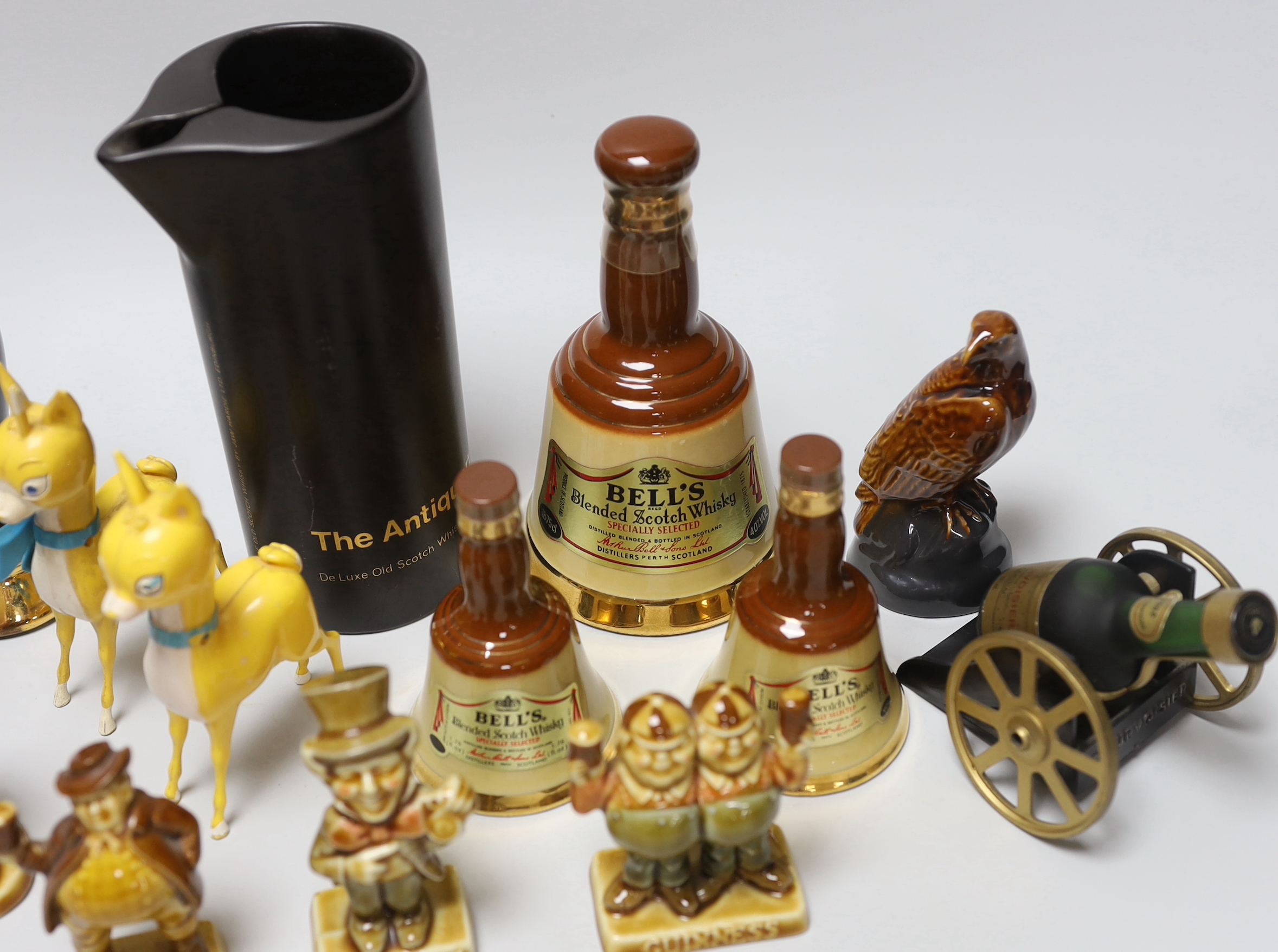 Four Wade Guinness novelty advertising ornaments together small quantity of breweryana including Bell’s Scotch whisky, the largest 18cm high